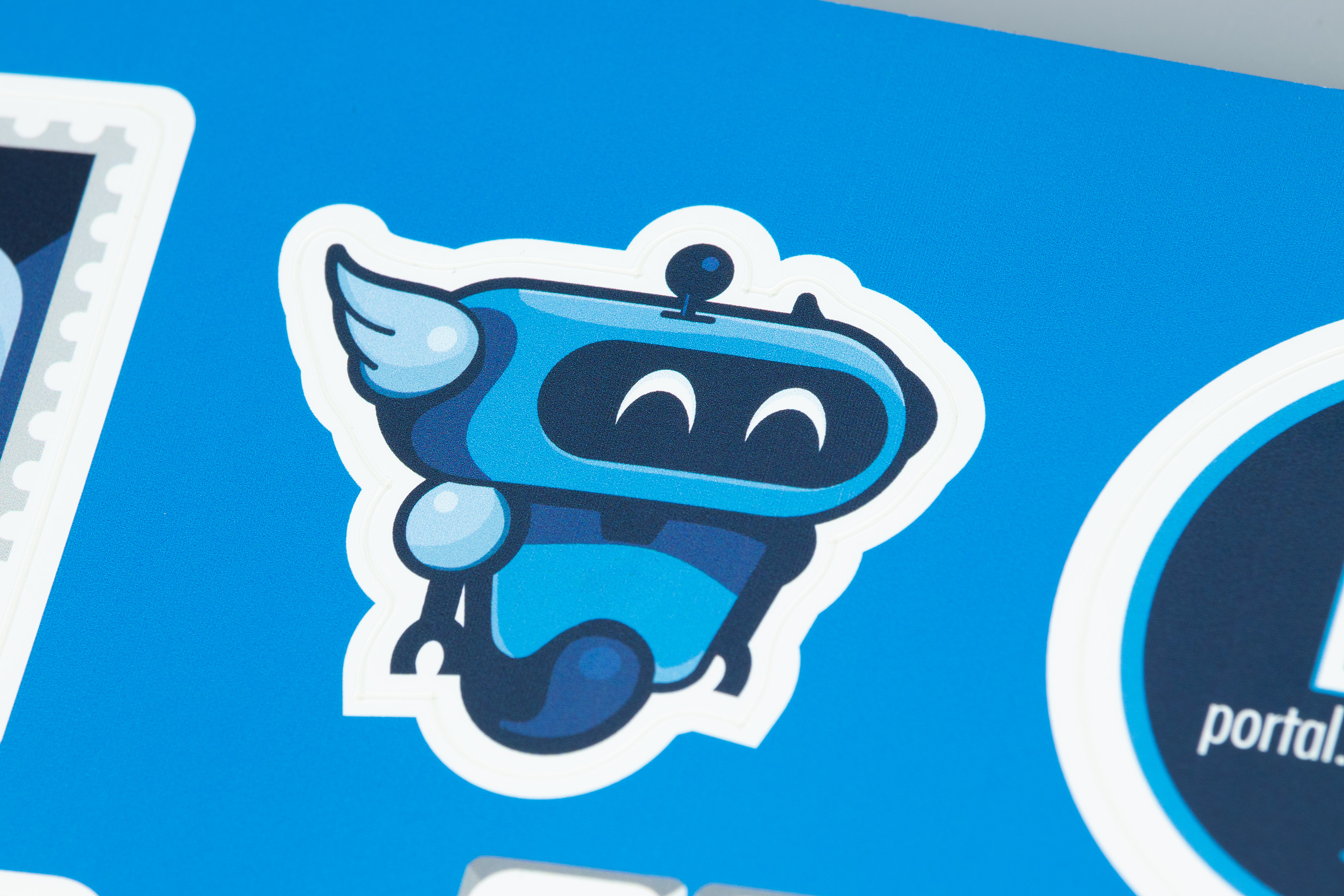 Close up of the illustrated robot sticker on the self-mailer.